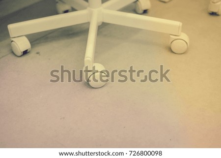 Close up on office chair wheel with contemporary background