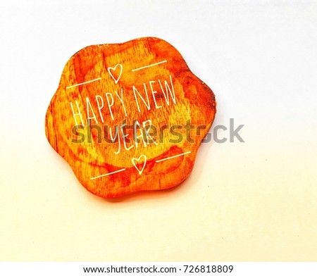 Closeup top view of wooden saucer with Happy new year banner on white background.