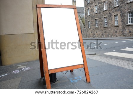 Blank ad space on a wooden stand in the street