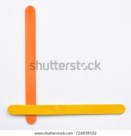 L, The English alphabet from wood sticks, isolated on white background.