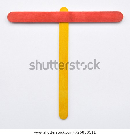 T, The English alphabet from wood sticks, isolated on white background.