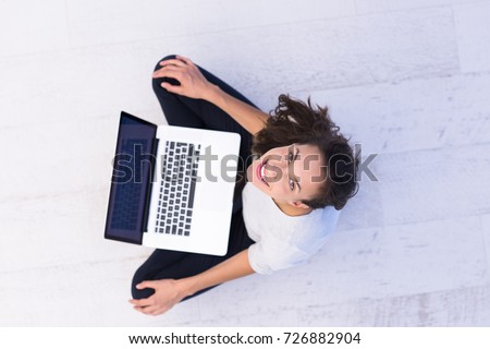 top view of a beautiful young women using laptop computer on the floor at home