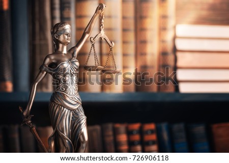 Statue of justice on library background.