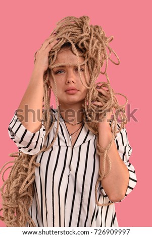 brunette girl dressed in stripes dress with a rope 
