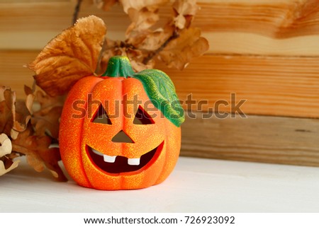 Picture of pumpkie over wooden background. Halloween funny concept.