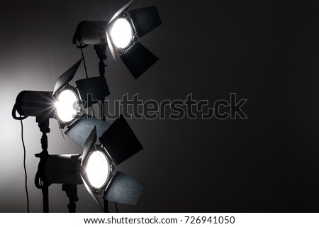 Several reflectors on the black background in photo studio. ready to do professional shooting Royalty-Free Stock Photo #726941050