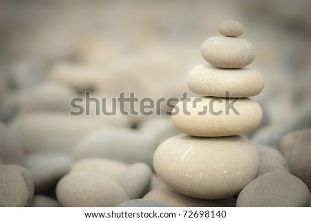 balanced stack of rocks with rocky background