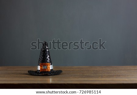 Happy Halloween decorations festival concept background.The hat of witch on modern rustic brown wooden at table home office.free space for creative design text and word.