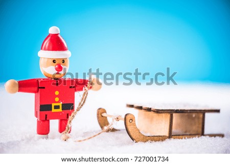 Funny Santa in winter scene on snow sledge.