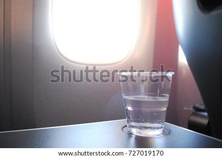 Cup Of Water In Airplane, Travel Royalty-Free Stock Photo #727019170