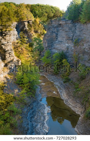 Photo looking down into a canyon with water at the bottom.