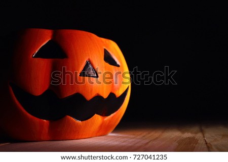 Scary pumpkin lantern with dark background, Halloween concept.