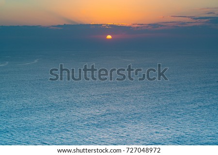 Peaceful atmosphere during sunrise or sunset over the ocean.