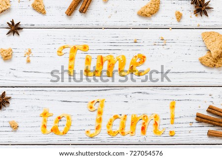 Food typography Time to Jam on white wooden rustic background. Orange jam lettering with cookies, cinnamon sticks and anise. Holiday dessert concept