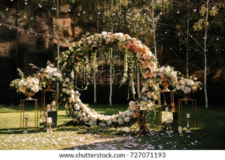 Wedding. Wedding ceremony. Arch. Arch, decorated with pink and white flowers standing in the woods, in the wedding ceremony area Royalty-Free Stock Photo #727071193