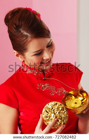 Young woman holding golden bowl