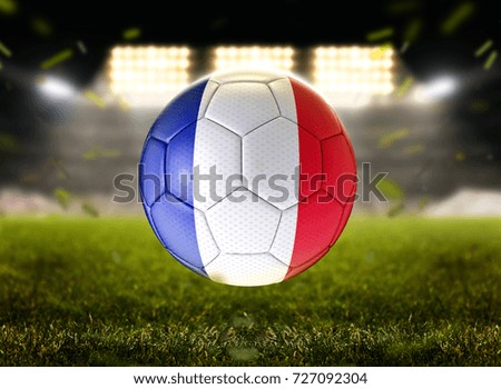 Football ball in stadium at night with France flag.