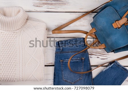 Handmade sweater, jeans and backpack. Casual warm outfit idea. Fall-winter women's clothing concept for fashion blog.