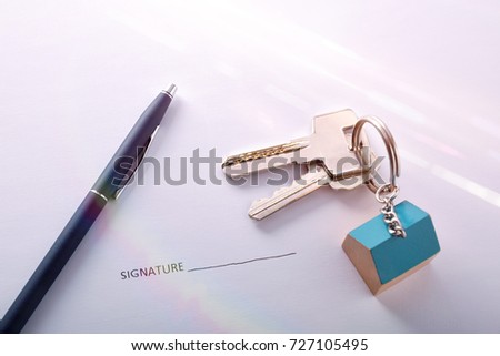 Keys and pen on paper to sign. Concept of contract signing for the purchase of a house.