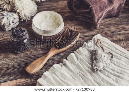 Natural spa set for woman. Hair care, pampering. Wooden comb, cream. Flat lay photography, top view, wooden background