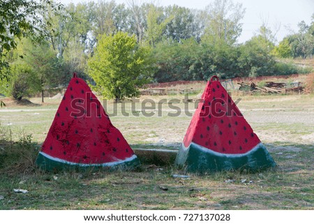 Two concrete anchors colored as a slice of watermelon