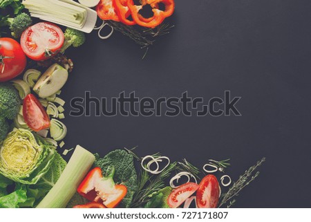 Vegetables border background. Fresh organic food, peppers, leek and greens on black. Natural food with copy space.