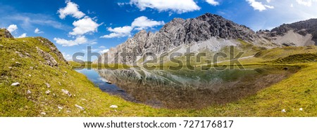 reflection panorama in european apls - gramais - lech velley - austria