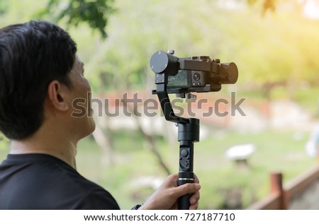 a man is using video recording equipment