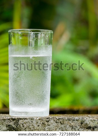 A glass of cold water in the garden