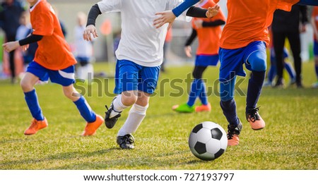 Running Children Football Soccer Players with Ball. Footballers Kicking Football Match on the Pitch. Young Teen Soccer Game. Youth Sport Background Royalty-Free Stock Photo #727193797