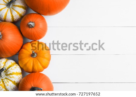Many orange pumpkins on white wooden background, Halloween concept