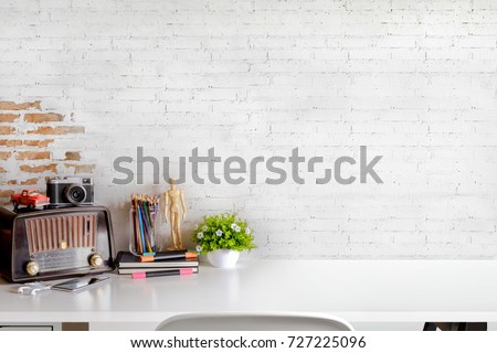 Stylish or designer minimalistic white table workplace with supplies , vintage radio, house plant. copy space for product display montage.