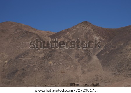 Large group of ancient petroglyphs on the hillsides at Cerro Pintados in the Atacama Desert in the Tarapaca Region of northern Chile. 
