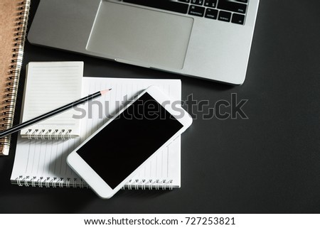 Top view of smartphone and computer, Business workplace equipment with copy space on black table