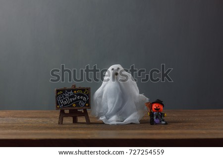 Happy Halloween decorations festival concept.Mix different items on modern rustic wood table at home office. Blur grey background with copy space.