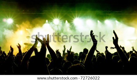 silhouettes of concert crowd in front of bright stage lights Royalty-Free Stock Photo #72726022
