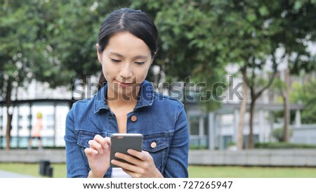 Woman use of cellphone in the park