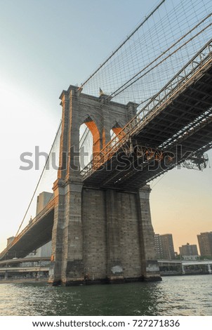 Brooklyn Bridge against the New York skyline at sunset