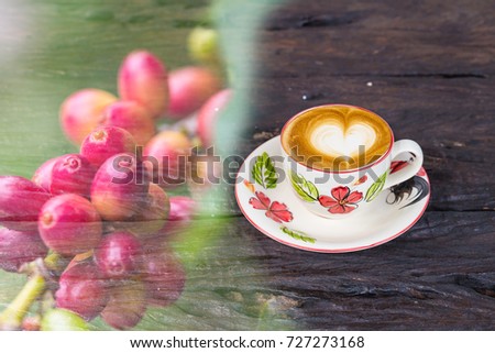 Double exposure of heart latte hot coffee cup with red coffee bean on tree 