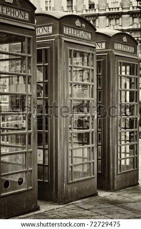 Vintage sepia image of three iconic London phone booths