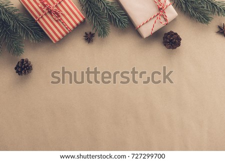 Christmas and New Year holiday  background top view border design with gift boxes, decorating items and copy space on light brown paper- vintage tone