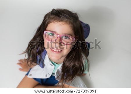 A girl with glasses is excited and nervous for her first day of school.
 Royalty-Free Stock Photo #727339891