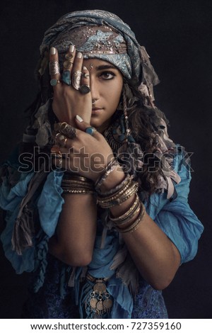 gypsy style young woman wearing tribal jewellery portrait Royalty-Free Stock Photo #727359160