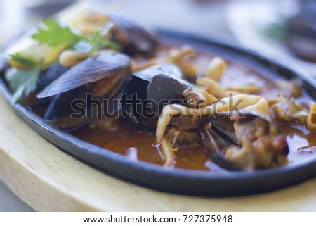 Steamed mussels in sauce served in a pan