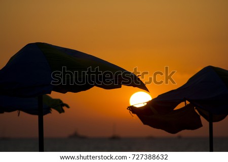Straw Umbrella in the Sunset