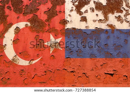 Turkish and Russia flags at the rusty background..  Concept photo