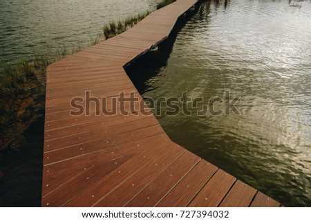 The walkway is made of wood.