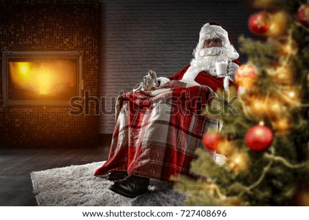 red old santa claus in home and fireplace 