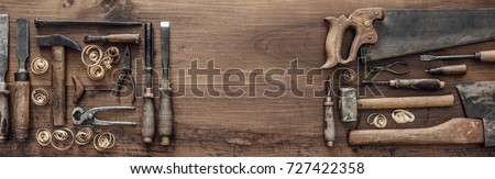 Collection of vintage woodworking tools on a rough workbench and blank copy space: carpentry, craftsmanship and handwork concept, flat lay Royalty-Free Stock Photo #727422358