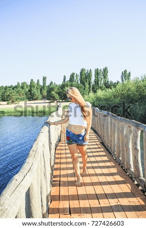 beautiful girl on a wooden bridge